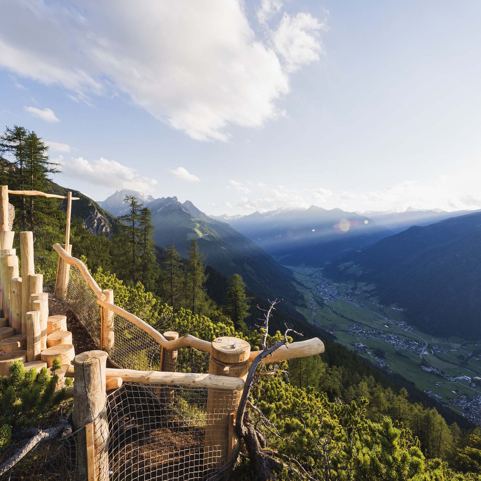Neustift: the active hotel in Stubaital Wooden viewpoint overlooking valley and mountains at sunset