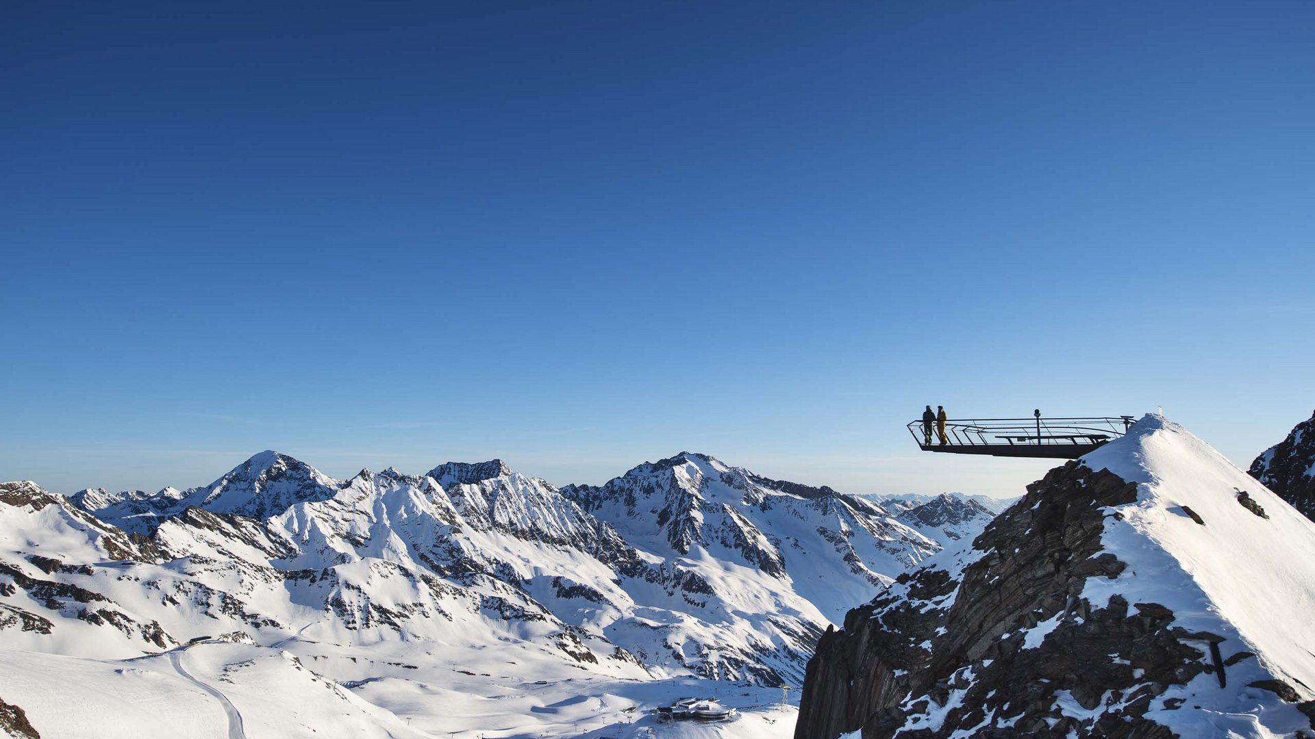 Things to do in Stubaital Viewing platform on snowy mountain overlooking snow-covered Alpine peaks