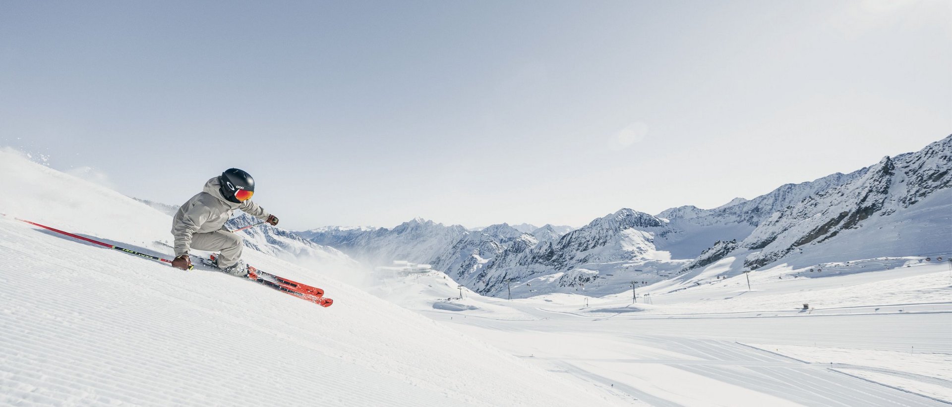 3 Gründe, warum März und April die besten Monate zum Skifahren sind Skifahrer fährt auf schneebedecktem Hang mit Bergen im Hintergrund