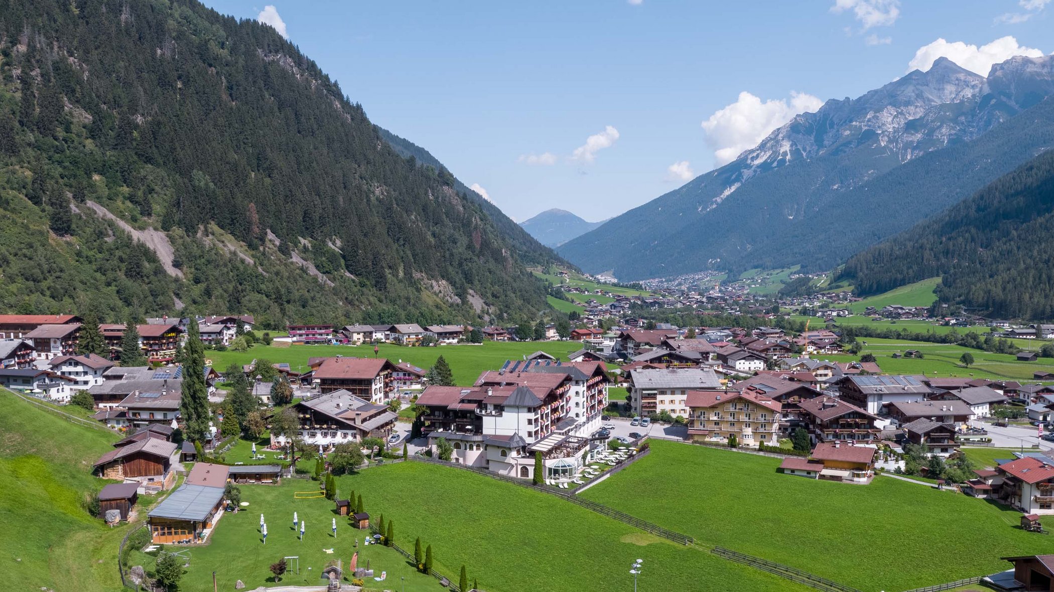 Things to do in Stubaital Village in a green valley with mountains and a small lake