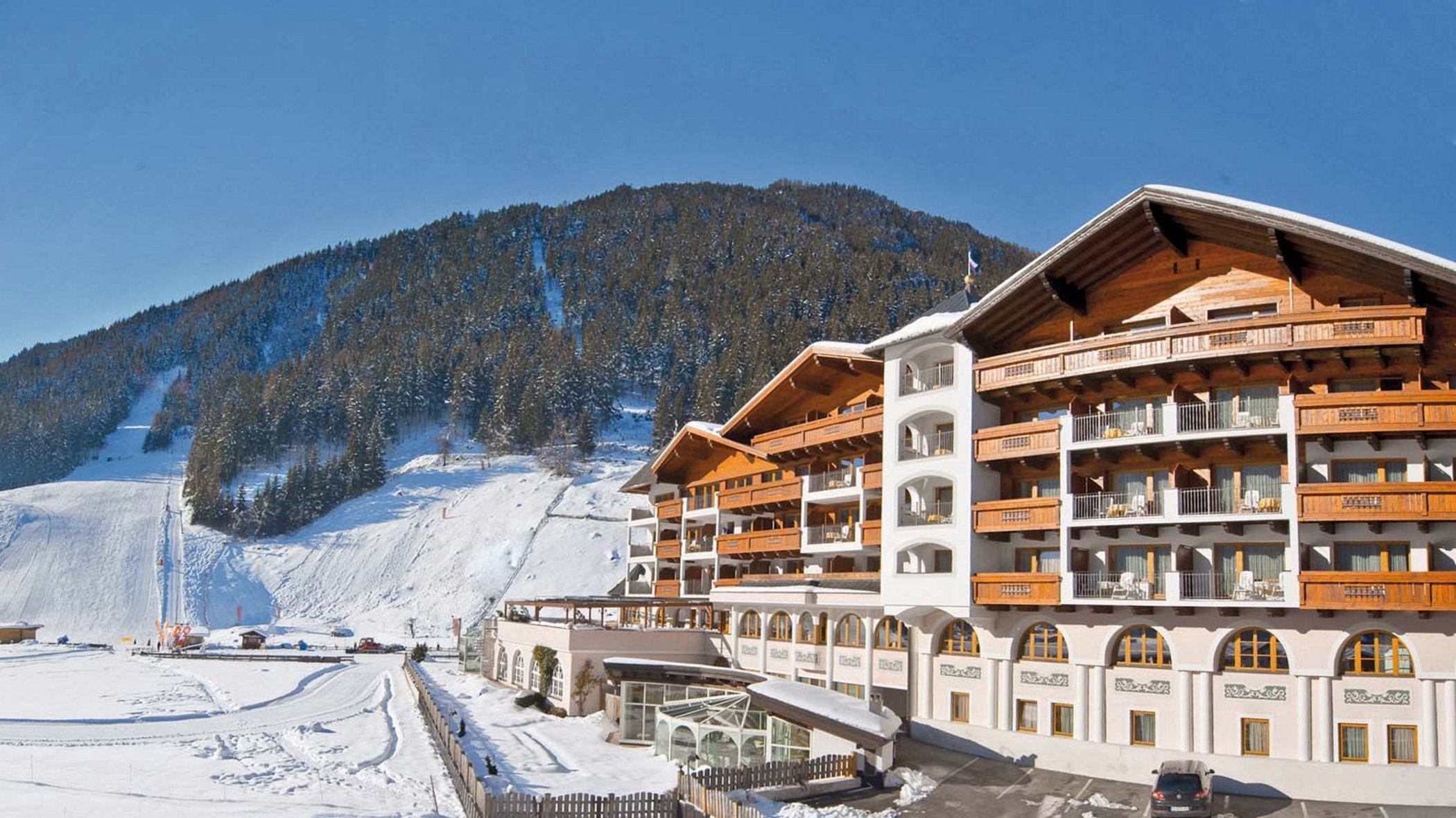 Your hotel in Neustift in Stubaital Sunny winter day with snow-covered hotel and mountain landscape
