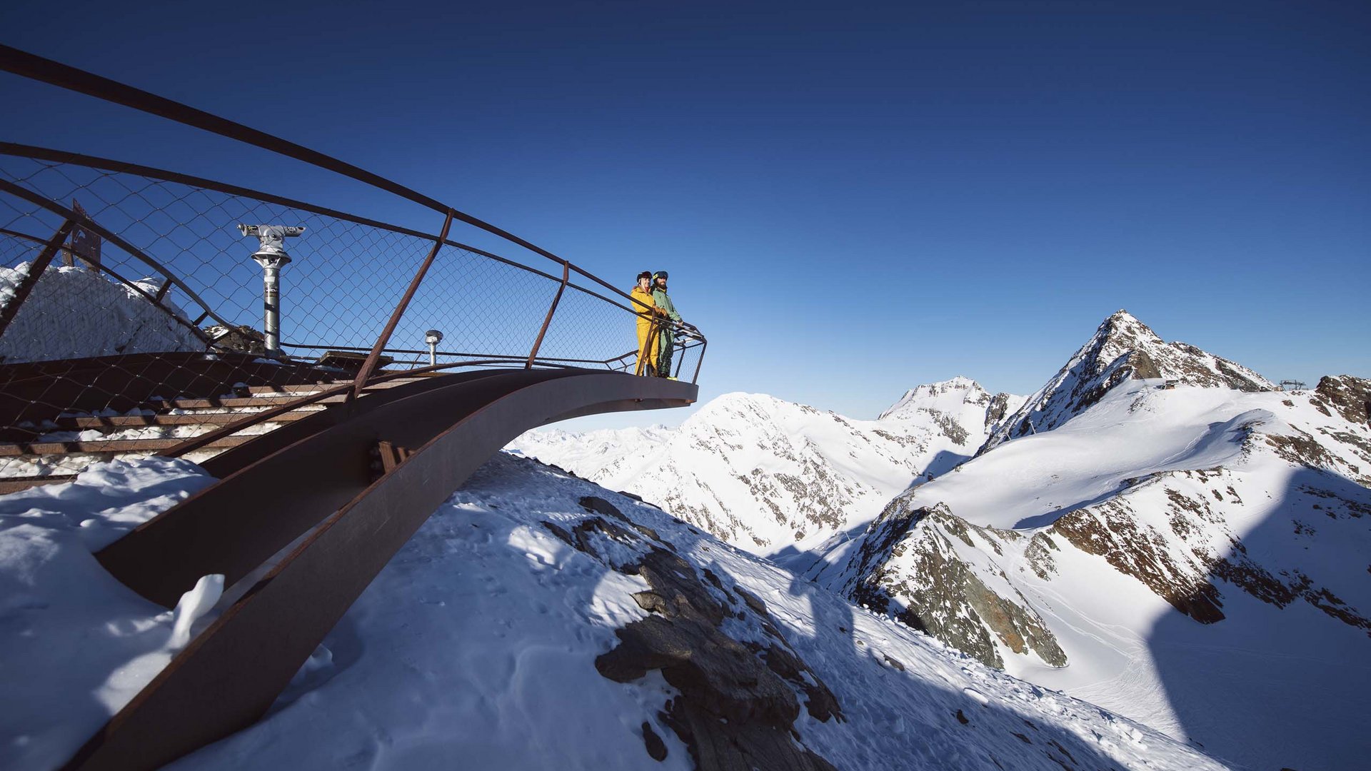 Things to do in Stubaital Two people on viewing platform overlooking snow-covered mountains