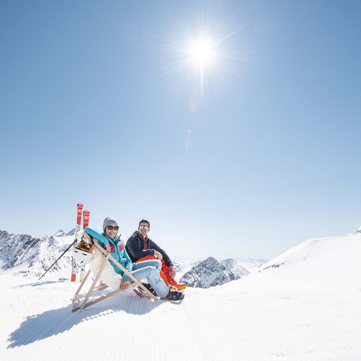 Neustift: the active hotel in Stubaital Two people relaxing on a deck chair in the snow on a sunny mountain day