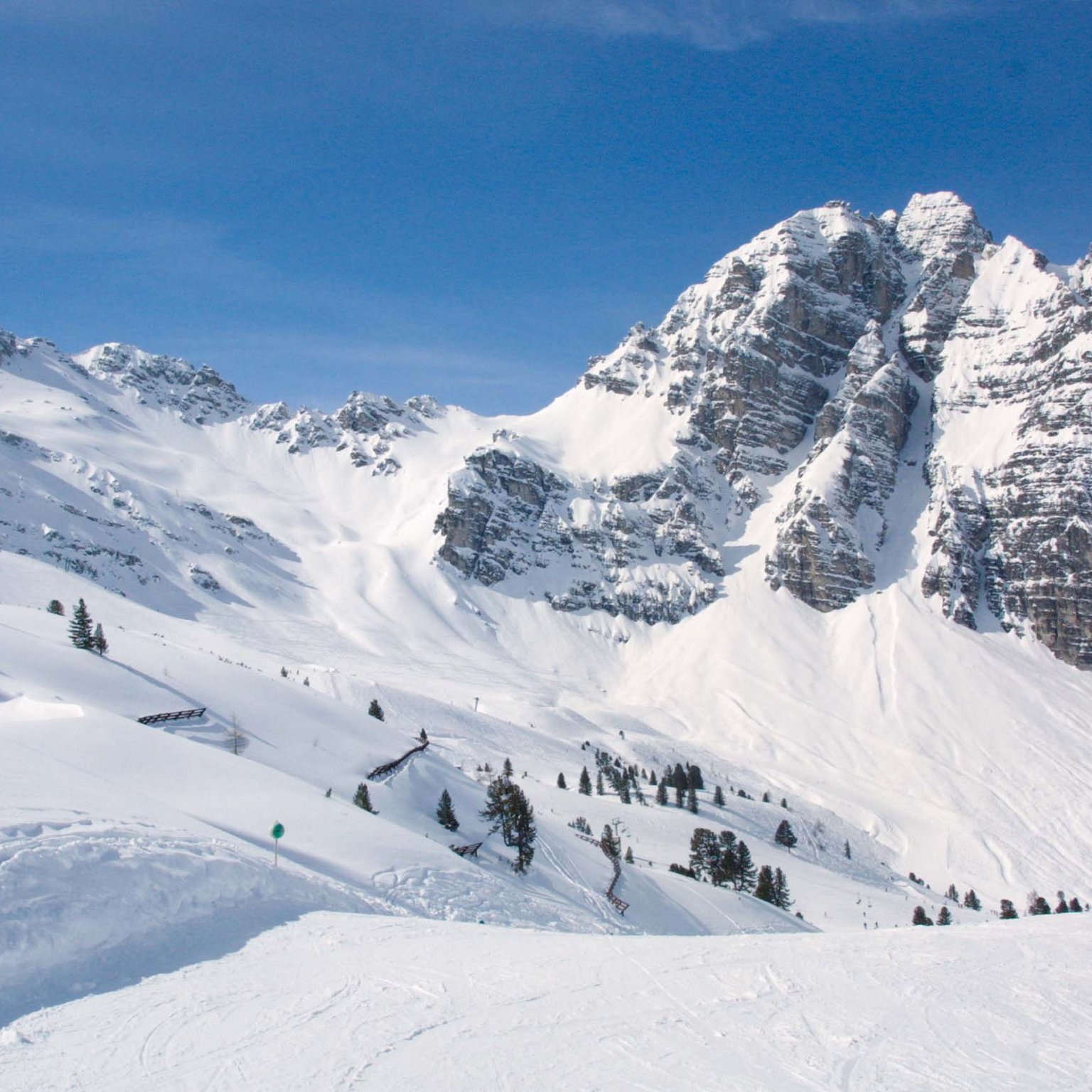 The Stubai Glacier Snow-covered mountains and ski slope under a clear blue sky