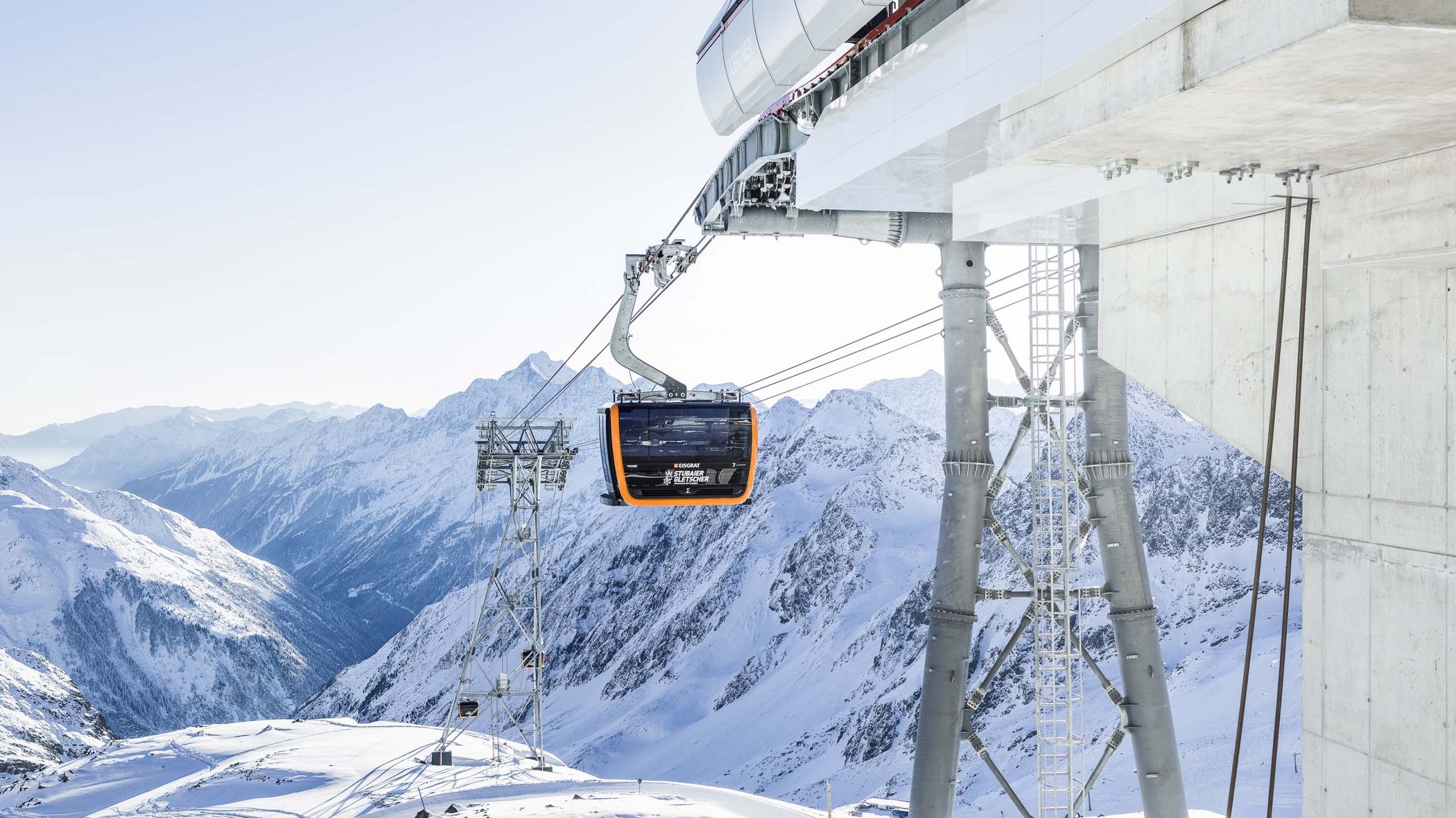 The Stubai Glacier Cable car on snowy mountain with view of snow-covered Alps
