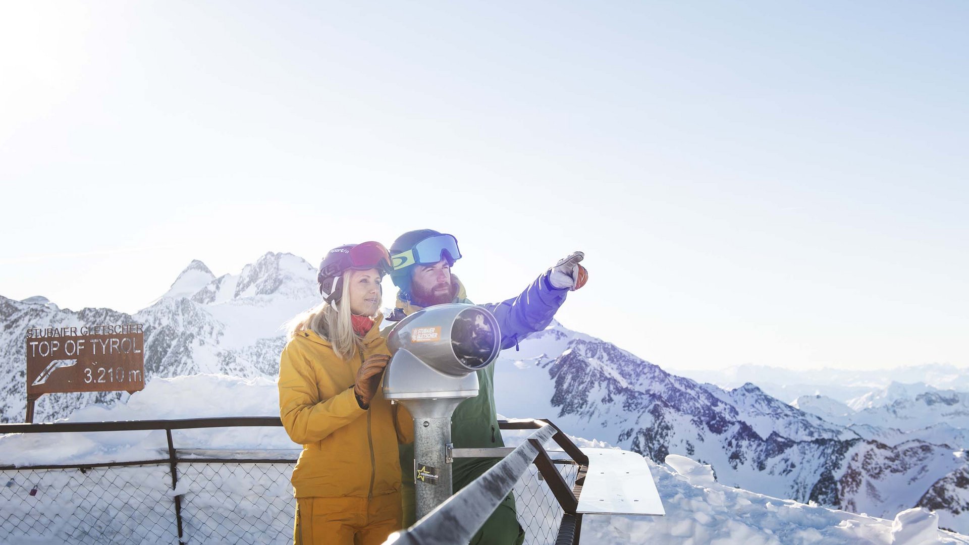 Skiing in Stubaital: offers Couple at Stubai Glacier with binoculars, viewing snow-covered mountains